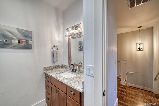 bathroom with vanity and hardwood / wood-style floors