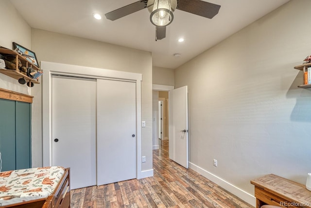 bedroom featuring ceiling fan, hardwood / wood-style floors, and a closet