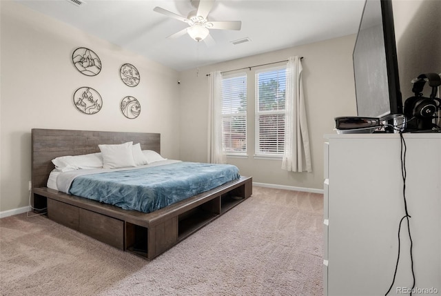 carpeted bedroom featuring baseboards and a ceiling fan