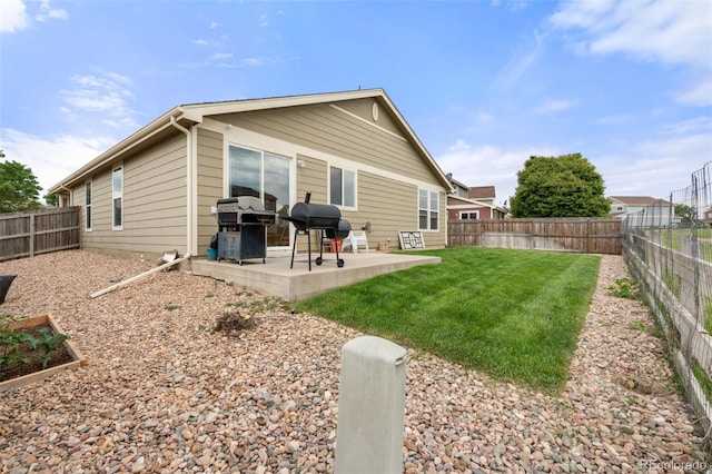 back of house featuring a patio area and a fenced backyard