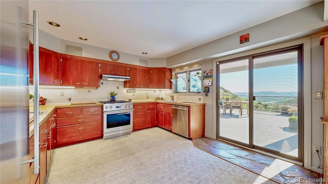 2602 Hidden Valley Rd, Sedalia, CO 80135 - kitchen with premium appliances, light countertops, under cabinet range hood, tasteful backsplash, and recessed lighting