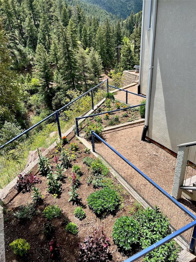 2602 Hidden Valley Rd, Sedalia, CO 80135 - view of yard featuring a forest view and a vegetable garden