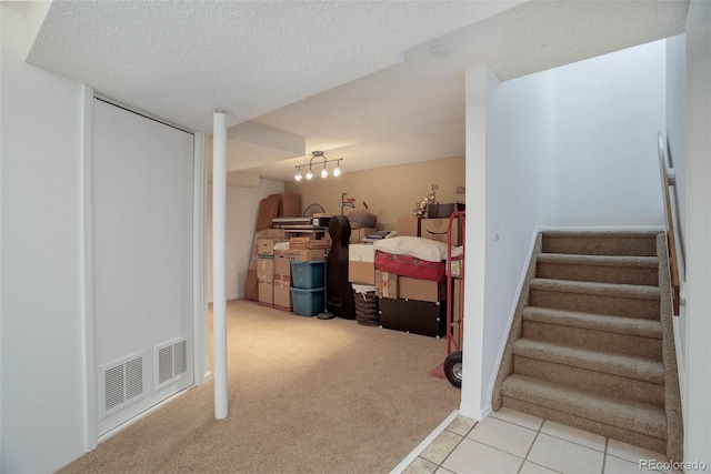 interior space featuring carpet floors and a textured ceiling