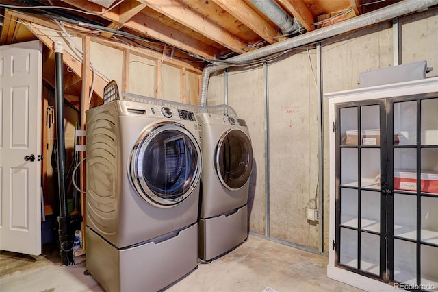 clothes washing area featuring separate washer and dryer