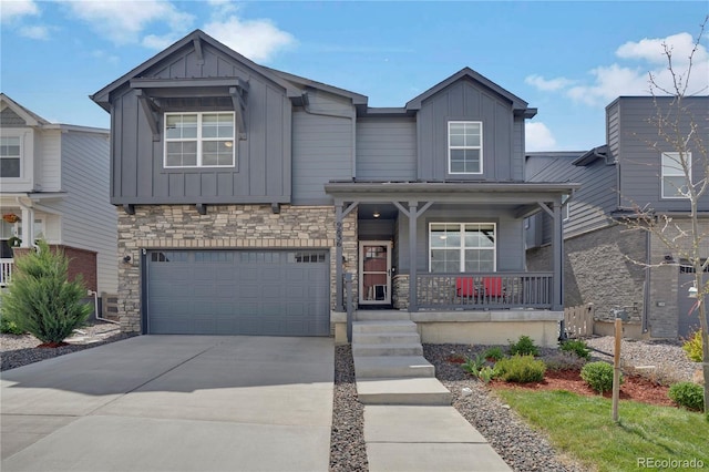 9836 Banner Peak St, Littleton, CO 80125 - craftsman house with board and batten siding, a porch, driveway, and a garage