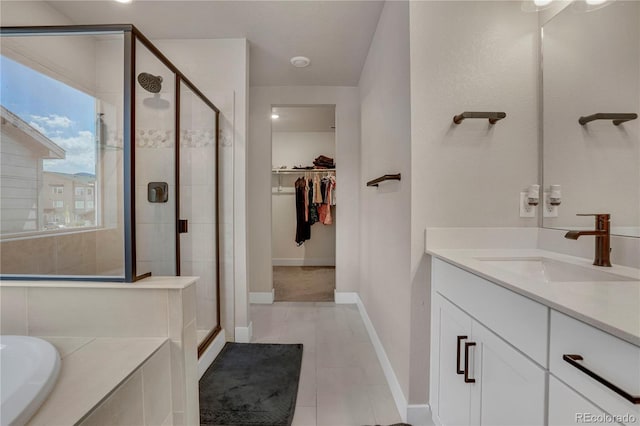 9836 Banner Peak St, Littleton, CO 80125 - full bathroom with a stall shower, a spacious closet, a garden tub, and vanity