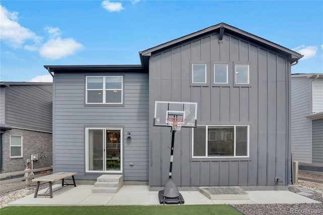 9836 Banner Peak St, Littleton, CO 80125 - back of house featuring board and batten siding and a patio