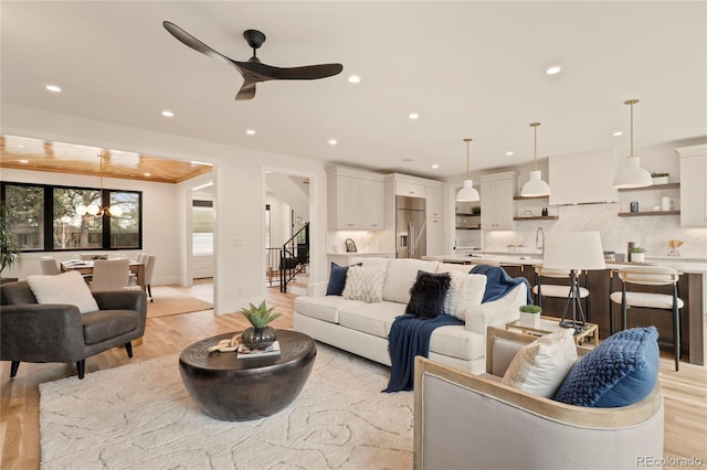 2610 N Monroe St, Denver, CO 80205 - living room featuring stairs, light wood-style floors, recessed lighting, a ceiling fan, and baseboards