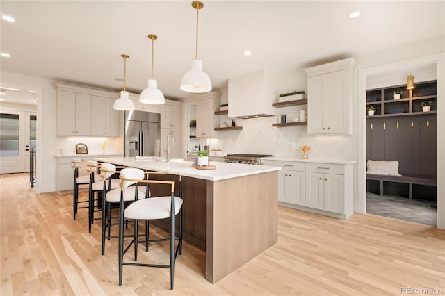 2610 N Monroe St, Denver, CO 80205 - kitchen with high quality fridge, open shelves, light countertops, recessed lighting, and a kitchen island with sink