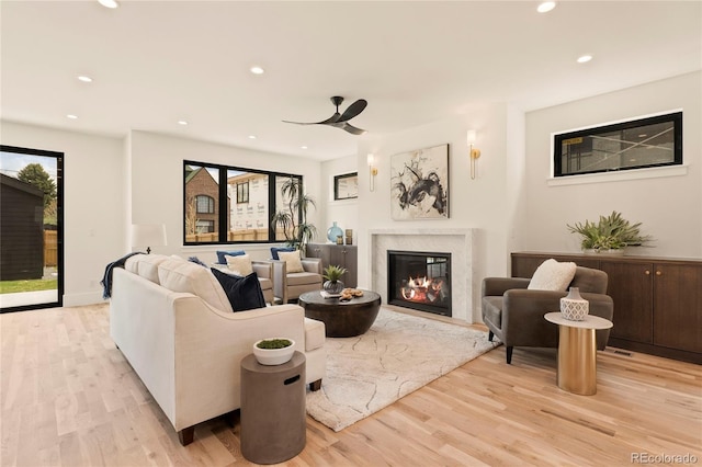 2610 N Monroe St, Denver, CO 80205 - living room with a high end fireplace, light wood-style flooring, recessed lighting, and a ceiling fan