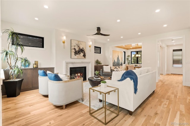 2610 N Monroe St, Denver, CO 80205 - living room with recessed lighting, light wood-style floors, a high end fireplace, and a ceiling fan