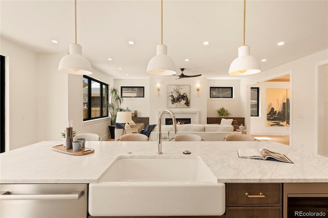 2610 N Monroe St, Denver, CO 80205 - kitchen featuring dishwasher, a sink, open floor plan, a lit fireplace, and recessed lighting