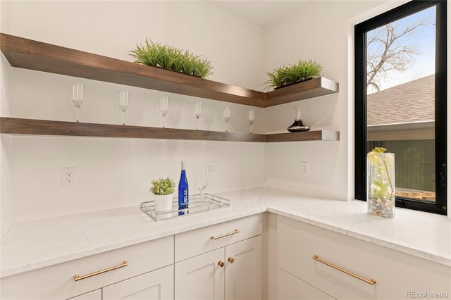 2610 N Monroe St, Denver, CO 80205 - kitchen featuring open shelves, light stone countertops, and white cabinetry