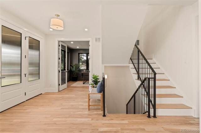2610 N Monroe St, Denver, CO 80205 - entryway with wood finished floors, stairs, recessed lighting, and french doors