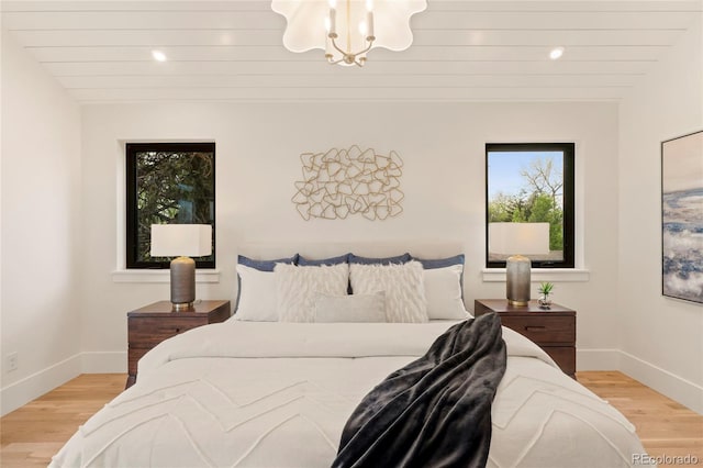 2610 N Monroe St, Denver, CO 80205 - bedroom with light wood-type flooring, baseboards, a chandelier, and recessed lighting