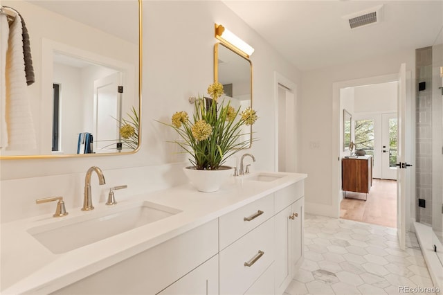 2610 N Monroe St, Denver, CO 80205 - full bathroom featuring double vanity, tile patterned floors, french doors, and a shower