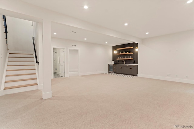 2610 N Monroe St, Denver, CO 80205 - finished below grade area featuring wet bar, light colored carpet, stairs, recessed lighting, and baseboards
