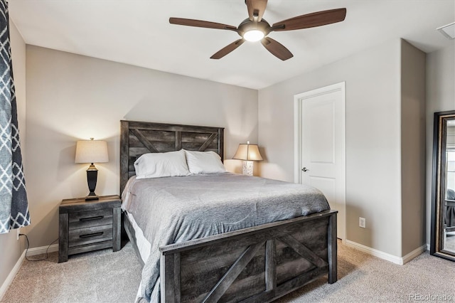 bedroom with light carpet, a ceiling fan, and baseboards