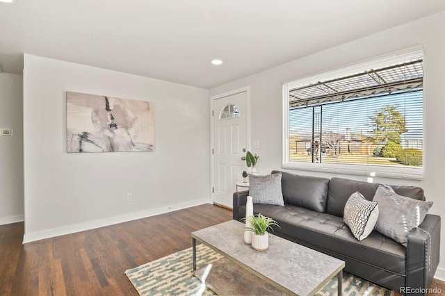 living area with baseboards, dark wood finished floors, and recessed lighting