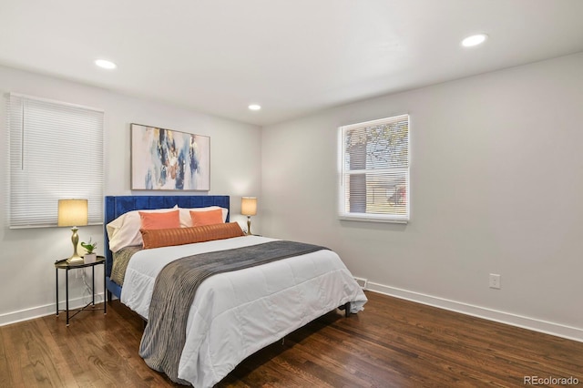 bedroom featuring baseboards, wood finished floors, and recessed lighting