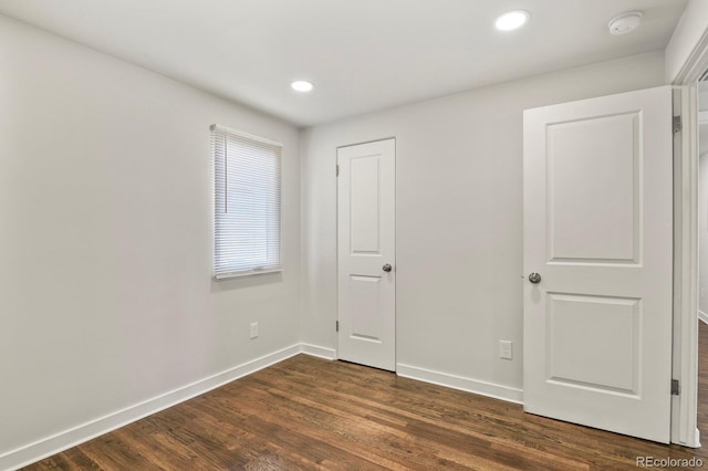 unfurnished bedroom with dark wood-type flooring, recessed lighting, and baseboards