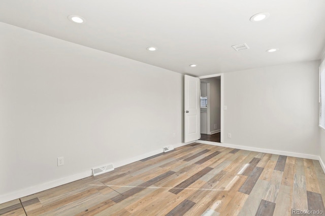 empty room with baseboards, recessed lighting, visible vents, and light wood-style floors