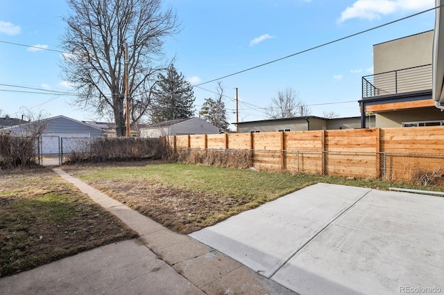 view of yard with fence and a patio