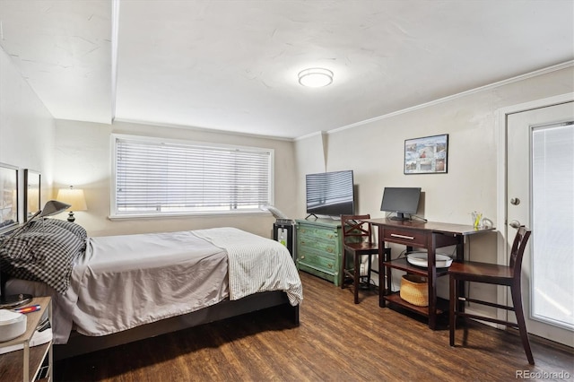 bedroom with dark hardwood / wood-style flooring and crown molding