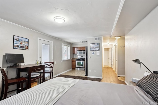 bedroom with ornamental molding and light hardwood / wood-style floors