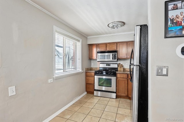 kitchen featuring ornamental molding, stainless steel appliances, and light tile patterned floors