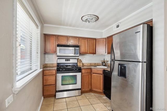 kitchen with ornamental molding, stainless steel appliances, sink, and light tile patterned floors