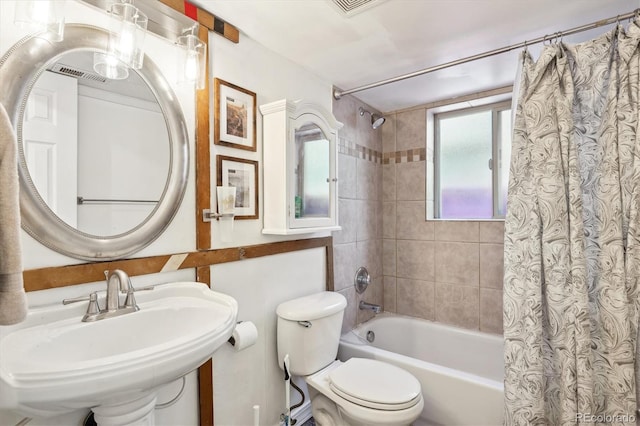 full bathroom with sink, shower / bath combo, and toilet