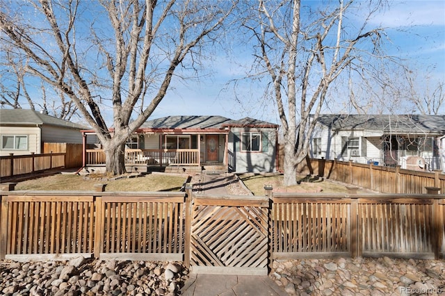 view of front facade featuring a deck and fence private yard