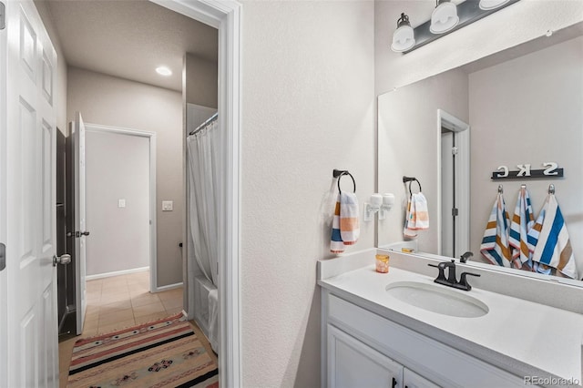 full bath featuring tile patterned floors and vanity