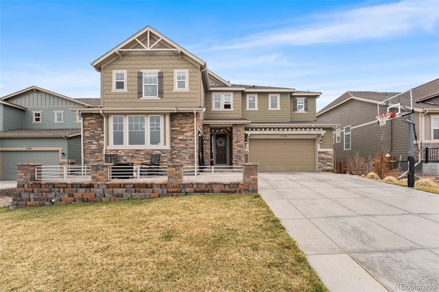 craftsman-style house with concrete driveway, stone siding, an attached garage, and a front yard
