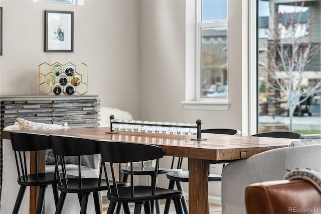 dining space with wood finished floors