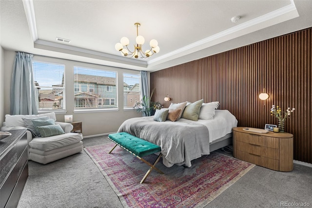 carpeted bedroom with a raised ceiling, a notable chandelier, crown molding, and visible vents