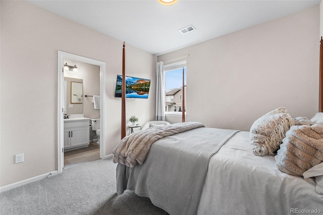 bedroom with baseboards, light carpet, and visible vents