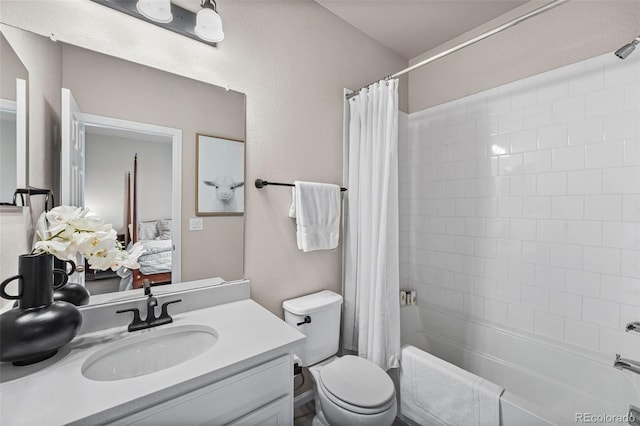 bathroom featuring shower / bath combination with curtain, toilet, a textured wall, ensuite bath, and vanity