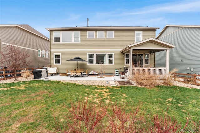 rear view of property with a yard, a patio area, and fence