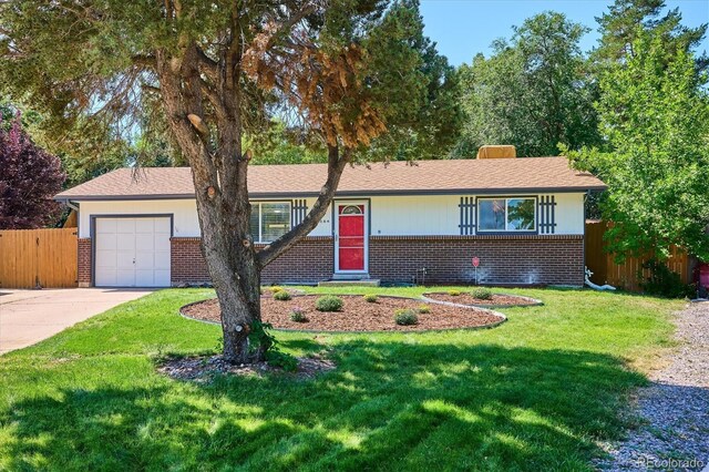 ranch-style house featuring a garage and a front yard