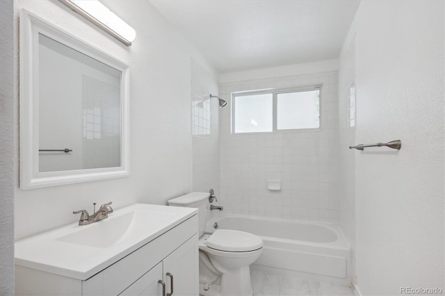 full bathroom with tiled shower / bath, toilet, and vanity