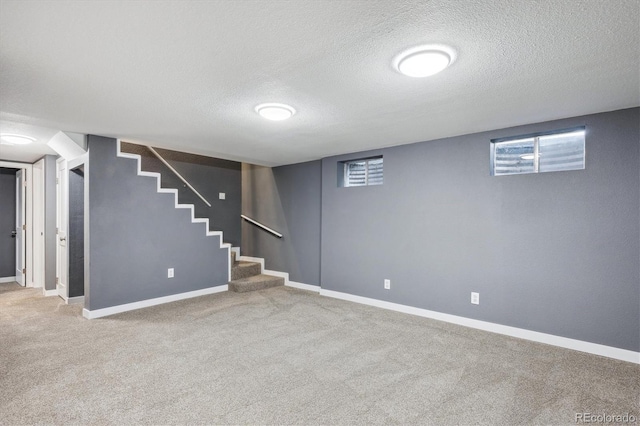 basement featuring a textured ceiling and carpet