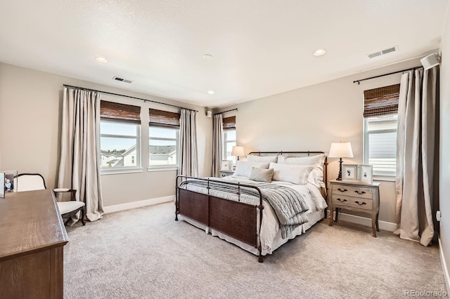 bedroom featuring light carpet, baseboards, and recessed lighting