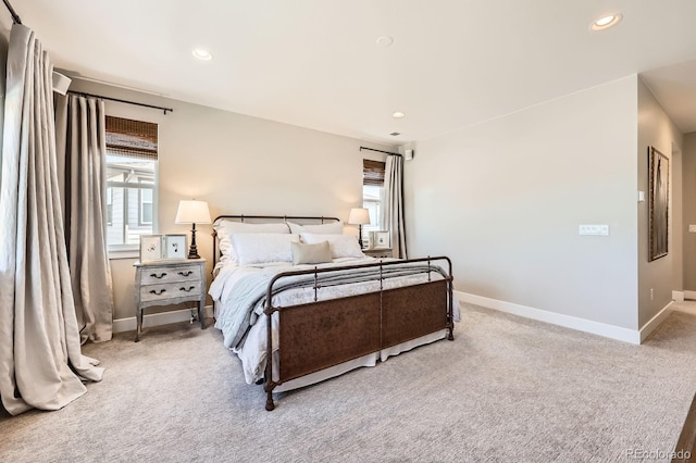 carpeted bedroom featuring baseboards and recessed lighting