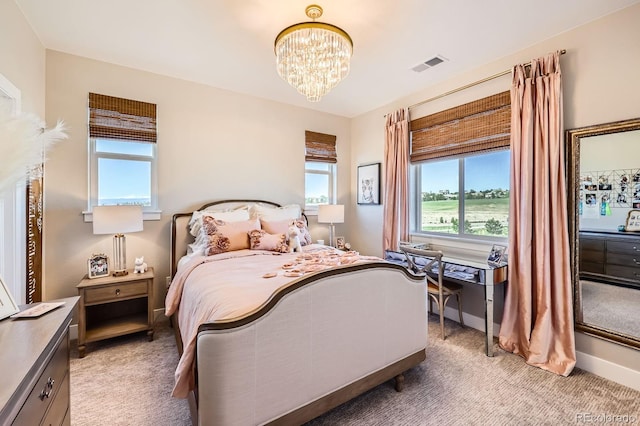 bedroom with light carpet, a chandelier, and baseboards