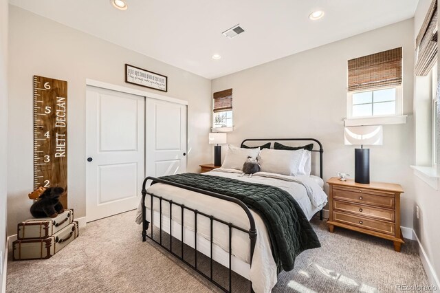 bedroom with carpet floors, multiple windows, a closet, and recessed lighting