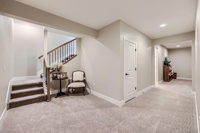 hallway featuring carpet flooring, stairway, baseboards, and recessed lighting