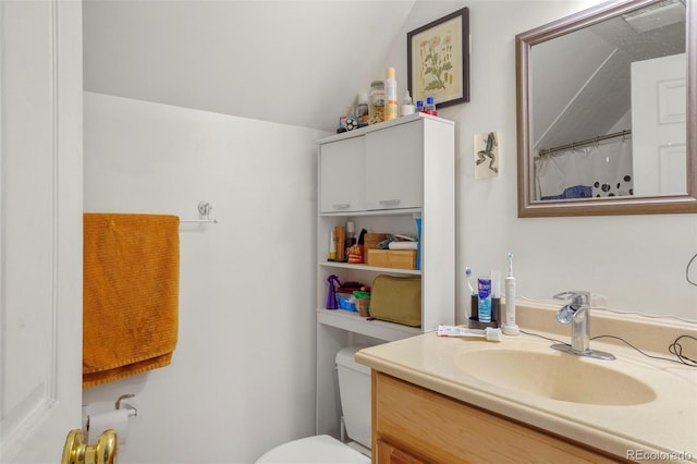 2087 S Grant St, Denver, CO 80210 - bathroom featuring toilet, vanity, and vaulted ceiling