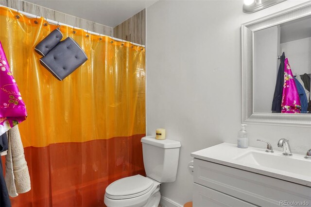 2087 S Grant St, Denver, CO 80210 - bathroom with toilet, curtained shower, and vanity